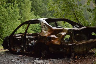 Abandoned car on field