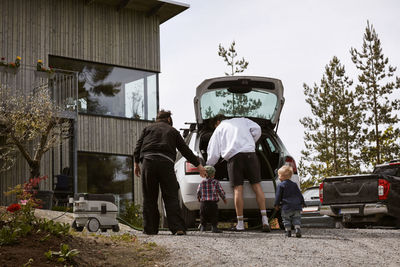 Man vacuuming car boot