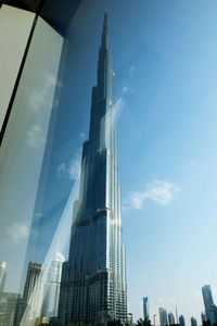 Low angle view of buildings against cloudy sky