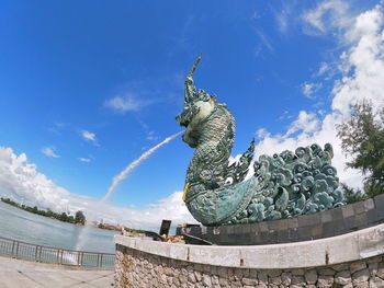 Low angle view of statue against cloudy sky