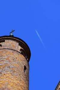 Low angle view of clock tower against clear blue sky
