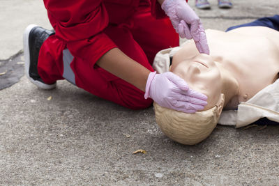 Paramedic performing cpr on mannequin