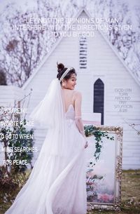 Woman with umbrella standing in front of temple