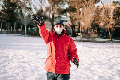 Portrait of man standing in snow