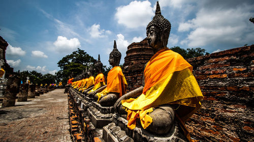 Statue of temple against cloudy sky 