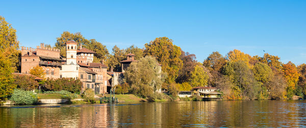 Scenic view of lake against clear blue sky