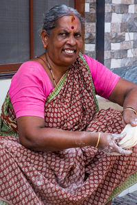 Smiling woman sitting outdoors