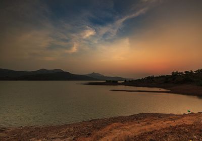 Scenic view of beach against sky during sunset