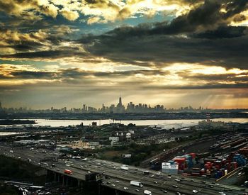 Cityscape against cloudy sky