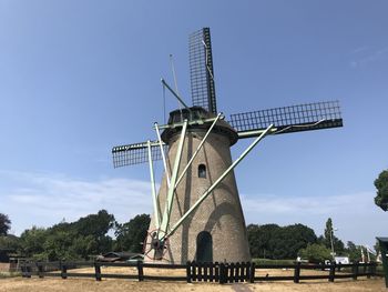 Low angle view of traditional windmill against sky