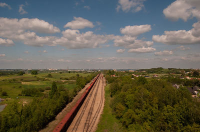 High angle view of freight train on railroad track amidst field