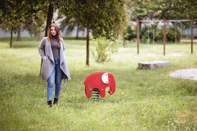 Full length portrait of woman on field