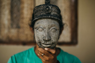 Close-up of man wearing mask at home