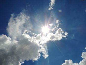 Low angle view of sun shining in sky