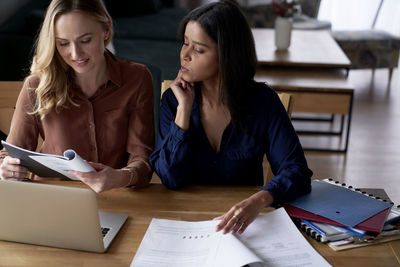 Young businesswoman using laptop at office