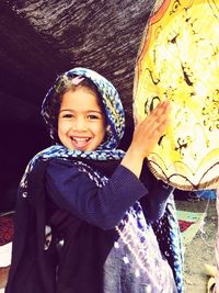 Portrait of smiling girl standing outdoors