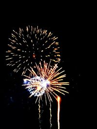 Low angle view of firework display at night