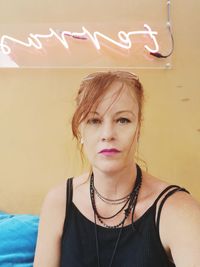 Portrait of woman against wall