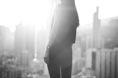 Midsection of woman standing against buildings