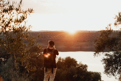 Rear view of man looking at sunset