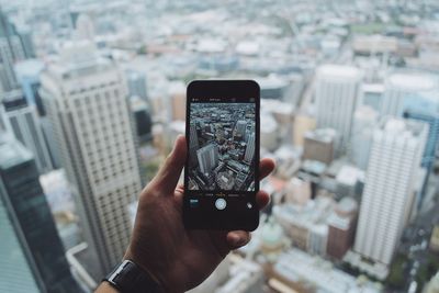 Cropped image of woman holding mobile phone