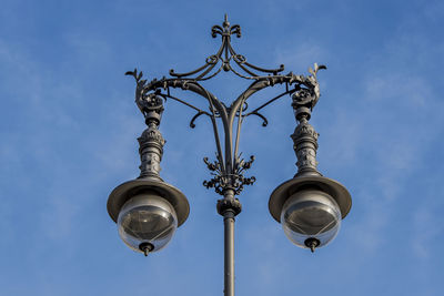 Low angle view of street lamp against sky