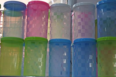 Low angle view of multi colored bottles in row