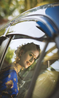 Portrait of young woman in car