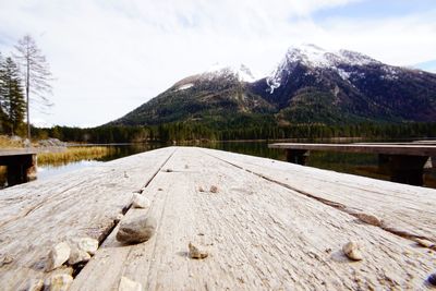 Scenic view of lake by snowcapped mountains against sky