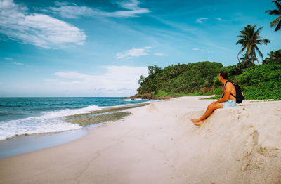 Full length of man on beach against sky