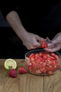 Midsection of man preparing food on table