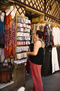 Rear view of woman standing in store