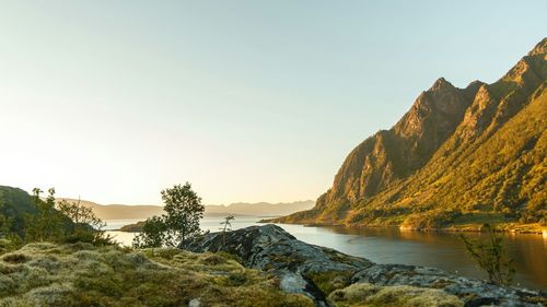 Scenic view of sea and mountains against sky