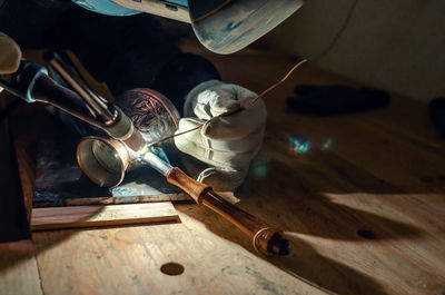 Welder's hands in gloves. repair of coffee turk by welding. close up