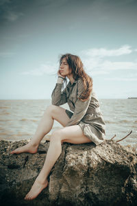 Young woman sitting at beach