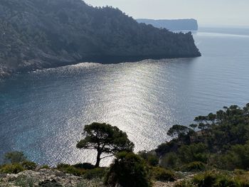 High angle view of rocks by sea against sky