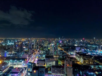 High angle view of illuminated cityscape against sky at night