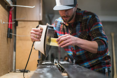 Man waxes his skis in a workshop in lake tahoe, ca