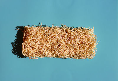 High angle view of needle on blue background