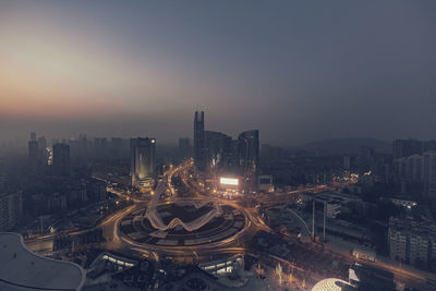 High angle view of illuminated buildings against sky at night