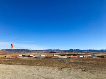 Scenic view of field against clear blue sky