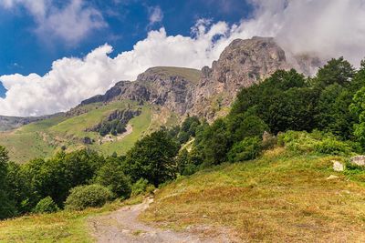 Scenic view of mountains against cloudy sky