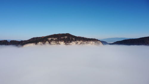 Scenic view of mountains against clear blue sky