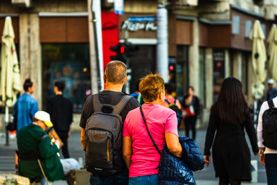 Rear view of people walking on street