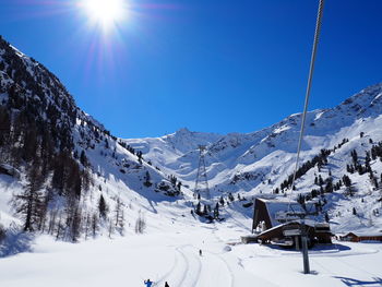 Scenic view of snow covered mountains against clear sky