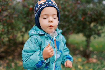 Portrait of cute girl standing outdoors