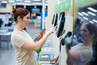 Side view of woman using mobile phone