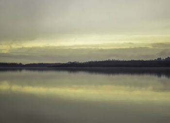 Scenic view of lake at sunset