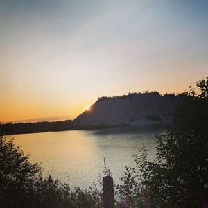 Scenic view of lake against sky during sunset