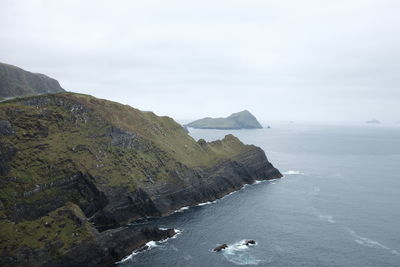 High angle view of sea by cliff against sky